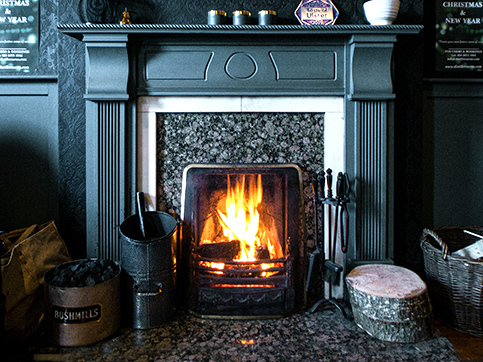 http://a%20grey%20stone%20fireplace%20with%20grey%20wood%20mantel%20and%20a%20burning%20fire